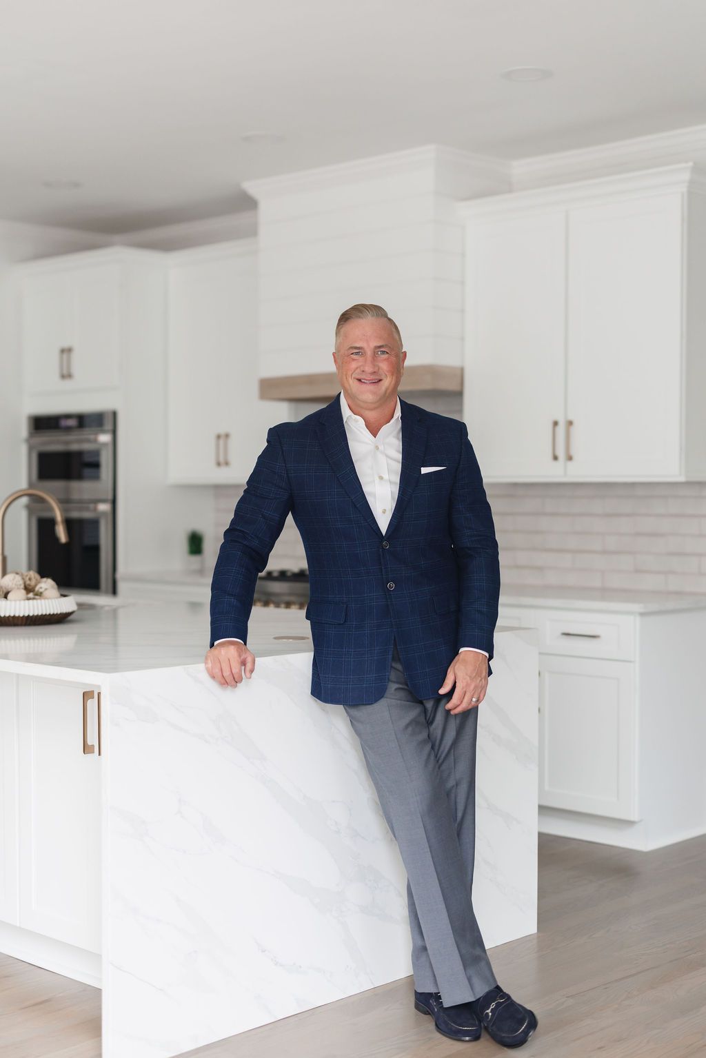 Wesley Harper standing in a renovated kitchen
